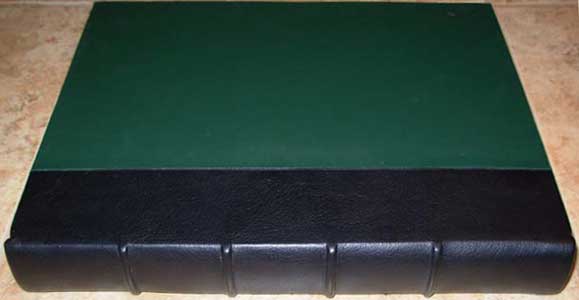 Book with (green) dyed fabric with black cover spine.